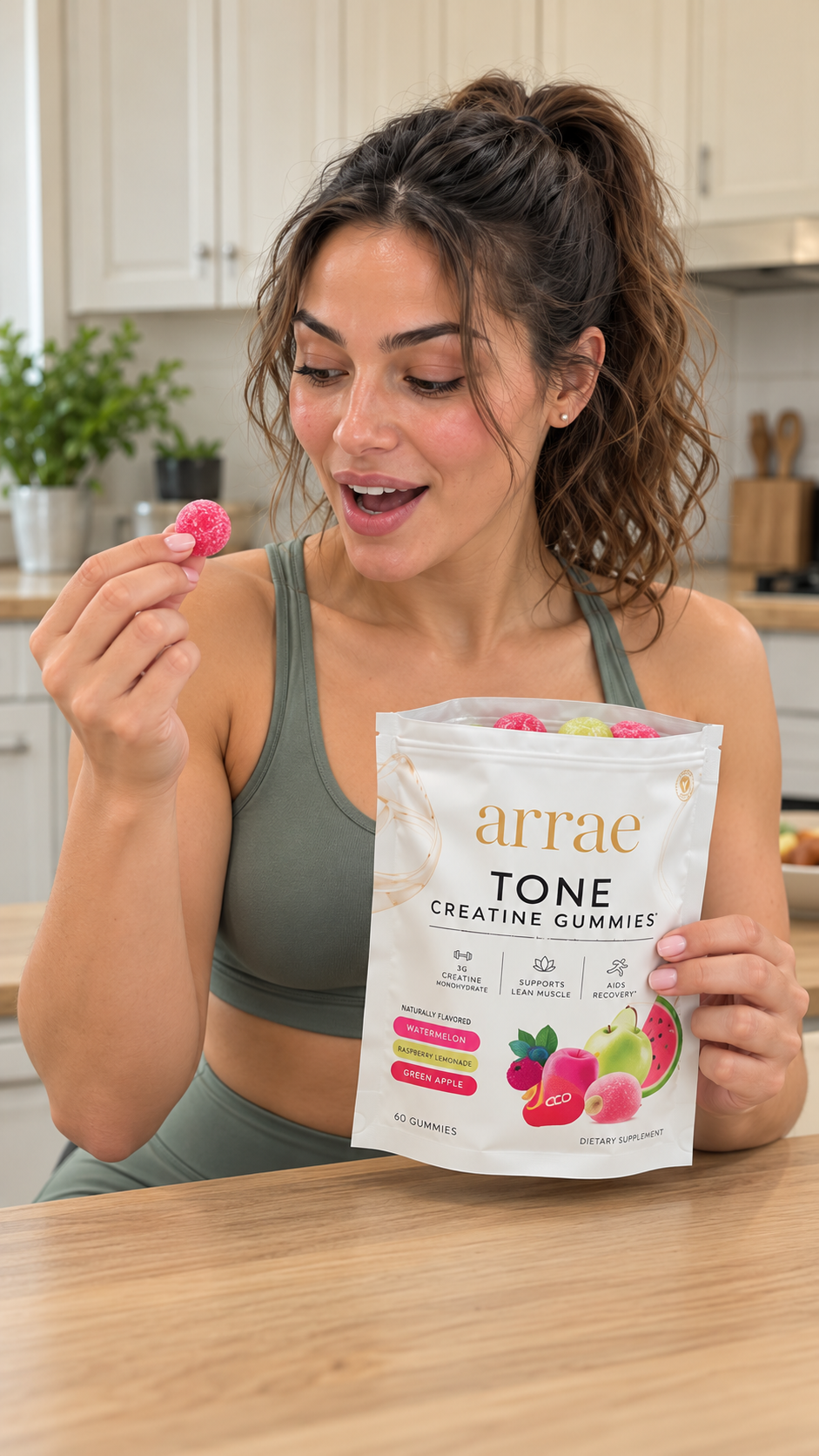 Creator opens the Tone variety pouch and holds up a pink gummy with a pleasantly surprised expression. The front of the pouch faces the camera.